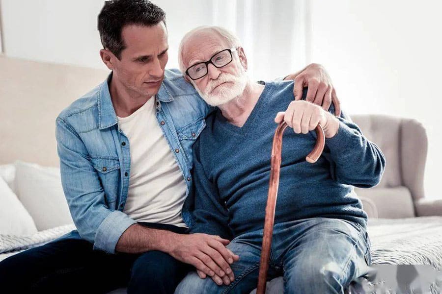 Son taking care of his father who's suffering from dementia.