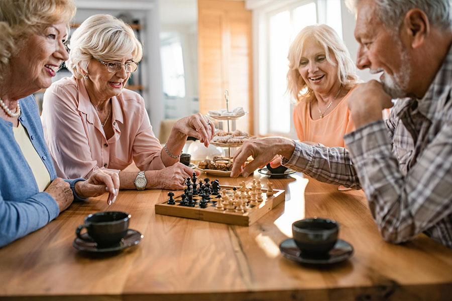 Seniors playing chess that helps with brain training.