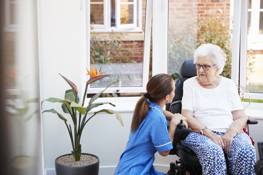 An image representing an assisted living setting, showcasing healthcare professionals providing specialized care and support to elderly residents