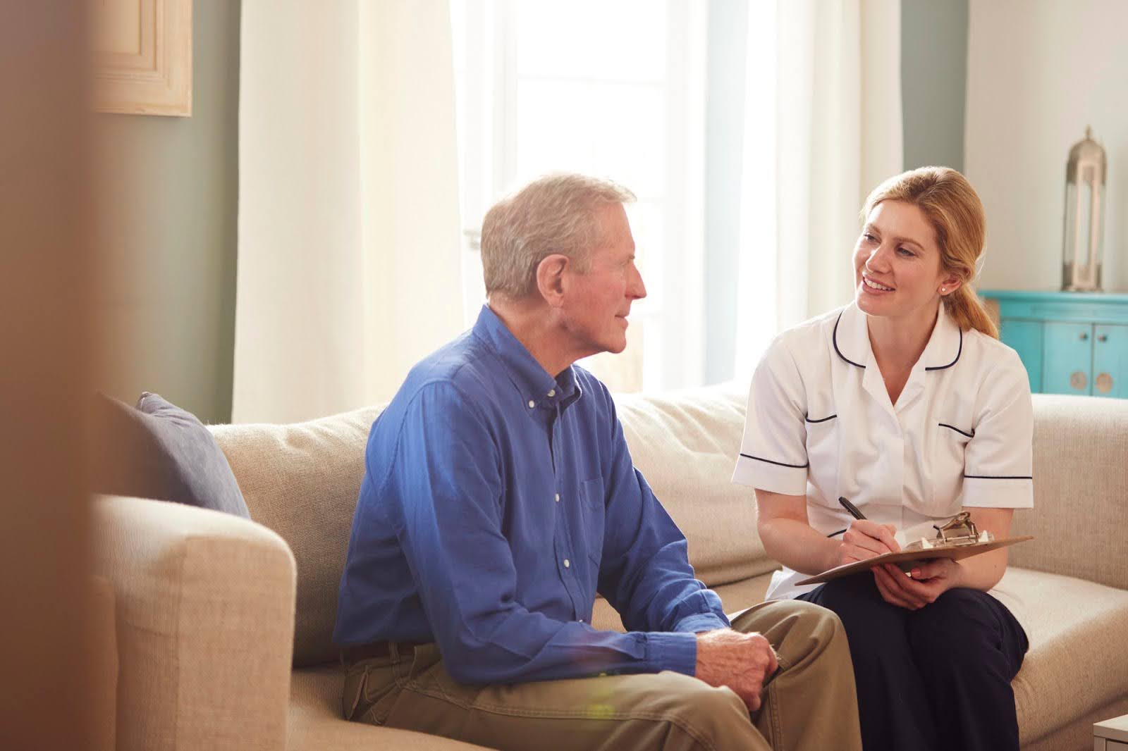 Compassionate staff member interacting with an elderly man at Cedar Creek, providing boutique memory care near Gaithersburg, MD.