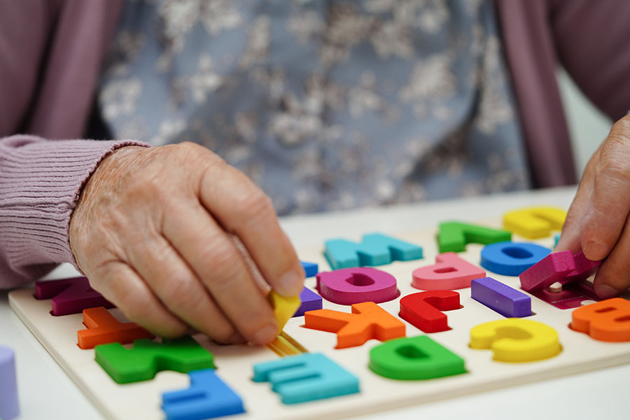 Asian elderly woman playing puzzles game to practice brain train