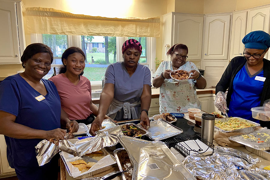 Caregivers preparing food for senior resident's at Cedar Creek memory care home
