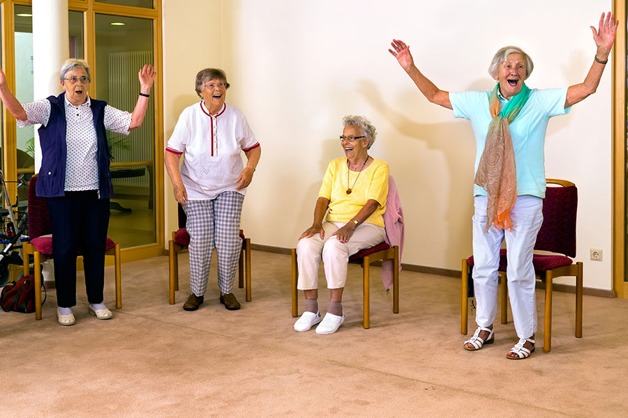 Older adults participating in a group exercise activity, showing when sundowning occurs and how routine supports dementia care